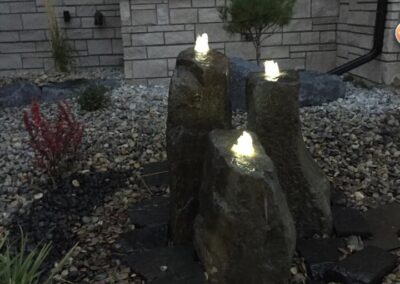 Water feature with landscape lighting