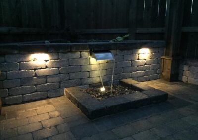 Water feature with landscape lighting