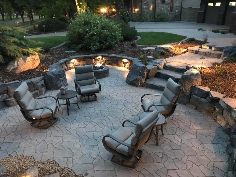 Custom outdoor stone design patio with comfortable chairs